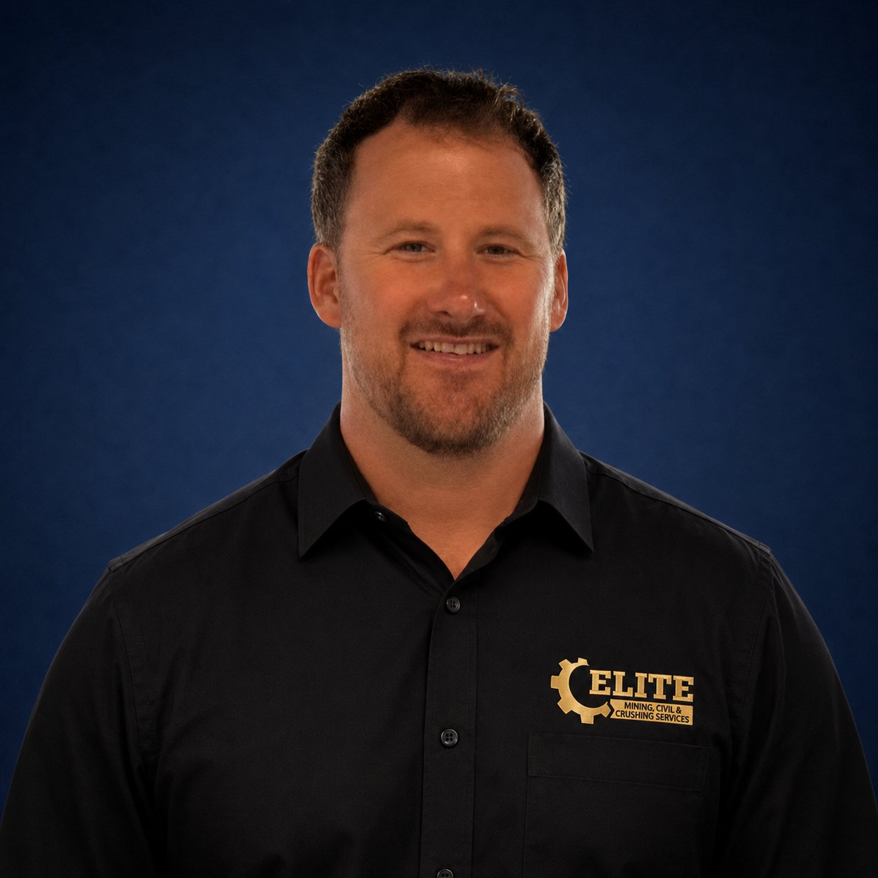 Shane Webb, Managing Director at EMCCS, professional studio portrait in Elite-branded polo