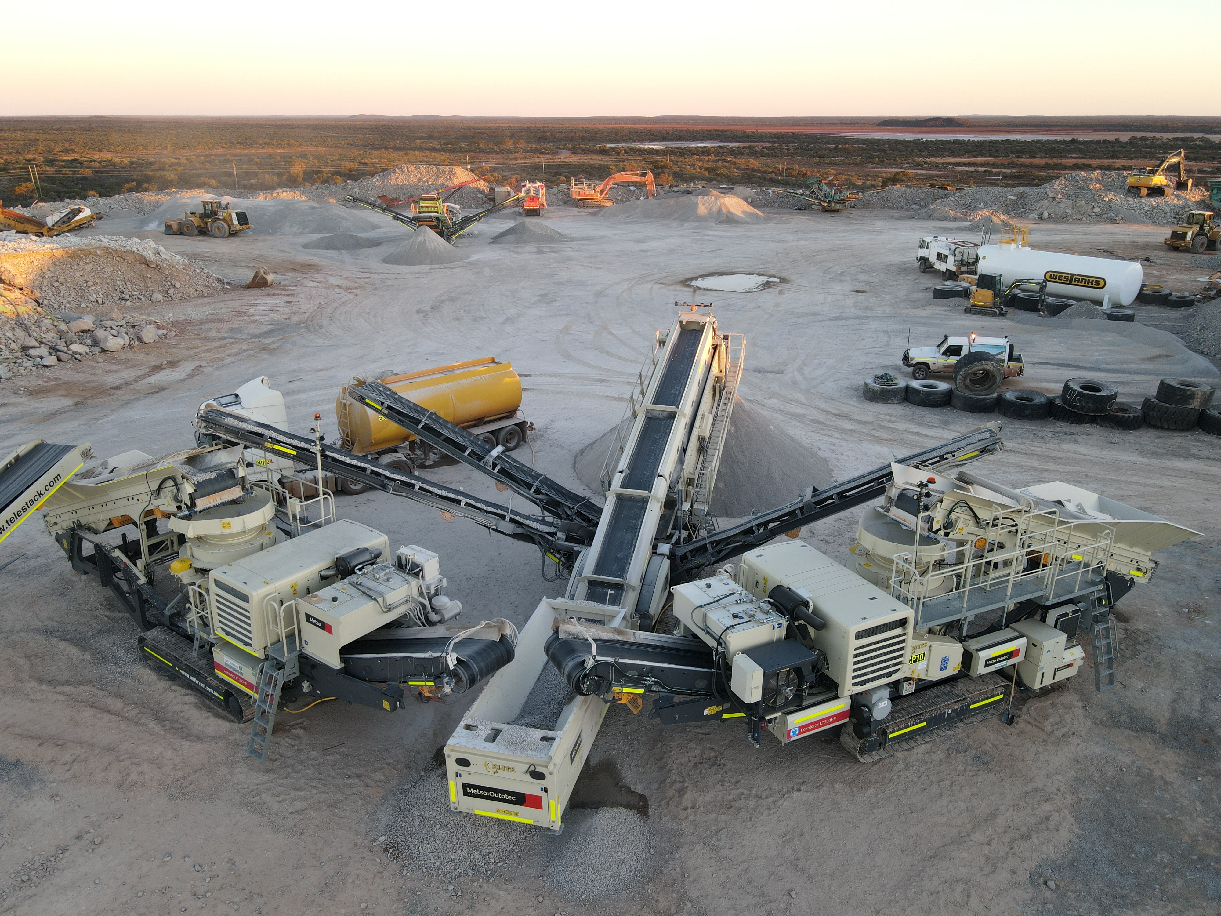 Top-down aerial of mobile crushing train at sunset — Kalgoorlie Super Pit fine filter